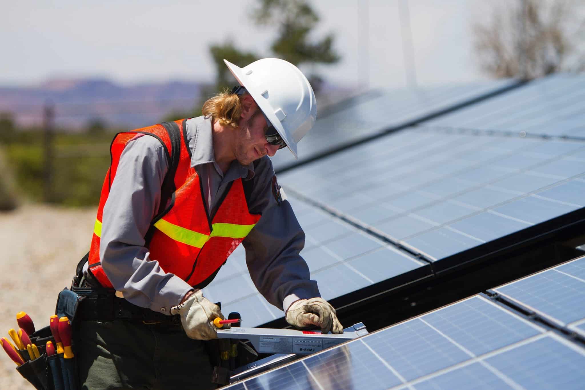 a person installing solar panels